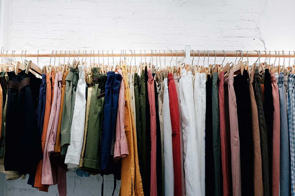 Trend fatigue rules in a world of overconsumption, a clothing rack has multiple aesthetics of various bottoms. Keeping up with micro-trends leads to overconsumptions and consumer&rsquo;s search for personal style is overwhelming. The every quickening trend cycle and trying to adhere to aesthetic labels is stifling.