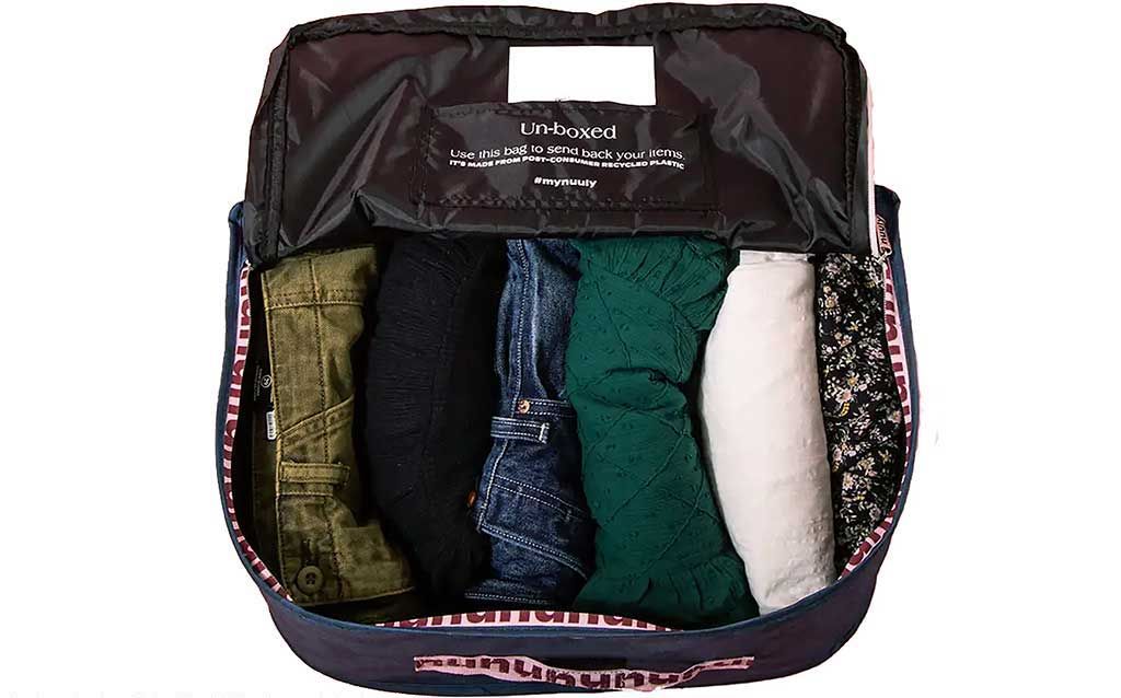 Fabric bag with clothes ordered from Nuuly for shipment with your rental fashion
